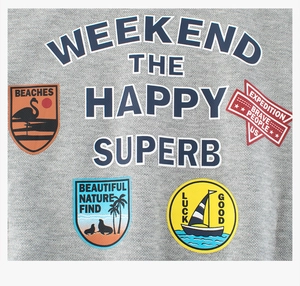Close-up of grey knit fabric with weekend adventure prints and colorful outdoor patches