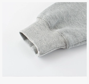 Macro view of ribbed cuffs on grey cotton sweatshirt showing fabric texture and stitching