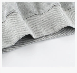 Detailed macro shot of grey ribbed knit cuff and stitching on children hoodie fabric