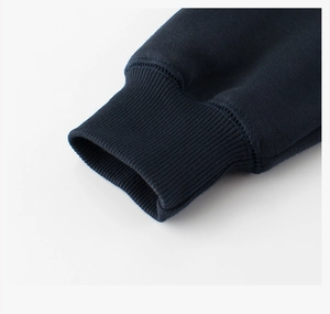Detail of navy blue fleece sweatshirt showing ribbed elastic cuffs and premium stitching