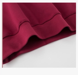 Close-up of ribbed cuffs on burgundy fleece sweatshirt showing quality stitching details