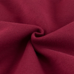 Macro shot of soft burgundy polar fleece fabric texture for children sweatshirt