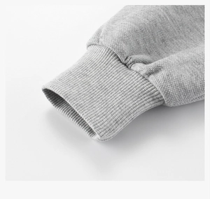 Close-up of gray hoodie ribbed cuff showing premium knitted texture and fabric detail