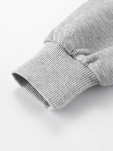 Detail of ribbed cuffs on a light grey spring zip-up hoodie for kids and teens