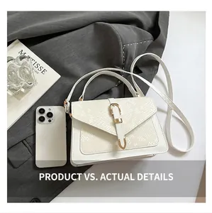 Sac à main blanc à rabat serpent avec smartphone pour illustrer l'échelle de taille réelle