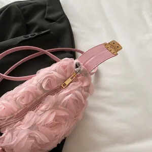 Detail of pink floral shoulder bag with 3D mesh roses and smooth gold-tone zipper