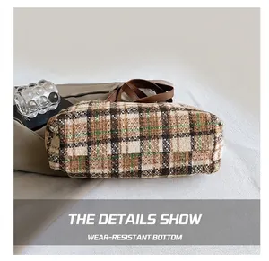 Detailed view of the durable base and retro plaid fabric of the casual tote bag