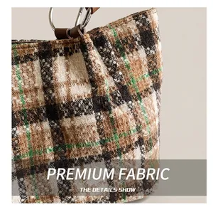 Close-up of checkered felt fabric texture and metallic ring handle on a tote bag