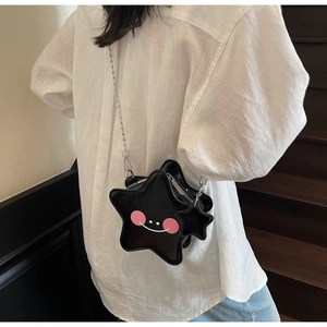 Detail of star-shaped crossbody bag with minimalist smile print and silver chain strap