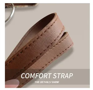 Detail of brown synthetic leather tote strap with precise stitching and metal ring