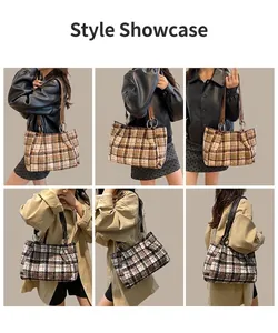 Detail of plaid tote bag featuring leather straps and silver metal hardware rings
