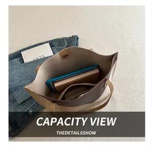 Interior view of large two-tone tote bag showing spacious capacity for tablets and books