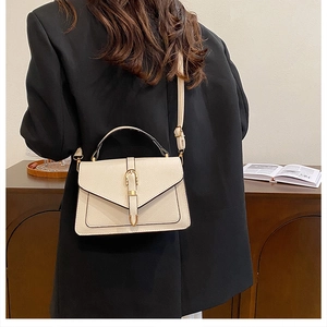 Creamy white pebbled leather crossbody bag with golden horseshoe buckle for women