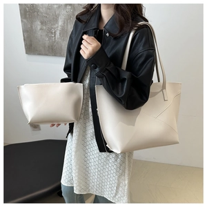 Detail of minimalist cream tote bag with geometric stitching and matching pouch pouch set