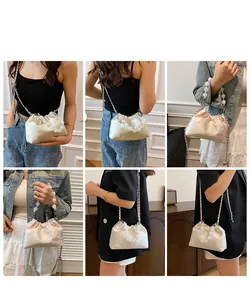 Detailed views of floral embroidered satin handbag with beaded handle and chain strap