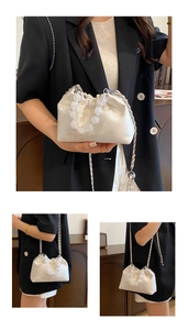 Detail of off-white silk cloud bag featuring embroidered texture and large frosted beads