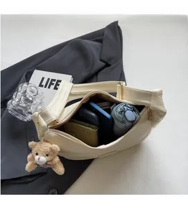 Internal view of large capacity crescent bag showing phone, wallet and folding umbrella