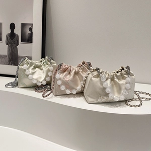 Elegant pleated satin evening bags with pearl handles in mint, pink, and beige colors
