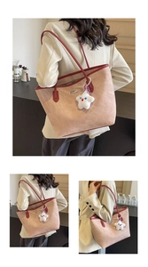 Detail of a pink tote bag with contrast red leather straps and a plush star charm
