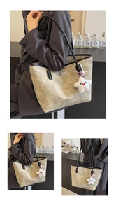 Detail of vintage beige tote bag with crinkled texture, black handles, and star charm