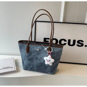 Blue washed texture tote bag with brown leather handles and a white star charm