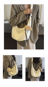 White hobo shoulder bag with bear pendant shown on model for size and fit reference