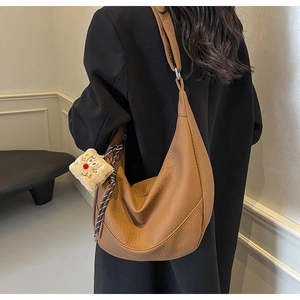 Detailed view of brown moon bag with lychee texture and cute toast pendant charm