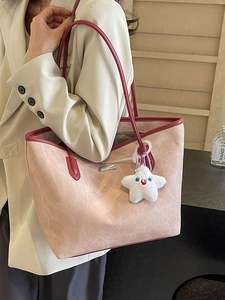 Chic pink suede tote bag with burgundy trim and star charm shown in a daily commute look