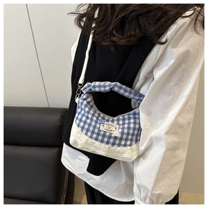 Detail of blue and white gingham crossbody bag with lace trim and Sweet Baby patch