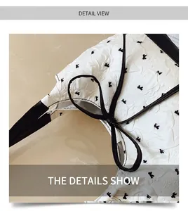 Detail shot of white wrinkled texture fabric with black rabbit patterns and leather trim