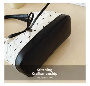 Detail showing precise stitching craftsmanship on the bow-patterned fabric and leather base
