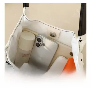 Detail view of the quilted tote bag interior with magnetic closure and daily storage space