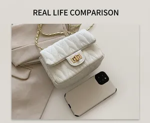 White quilted flap bag with gold rotary lock and chain strap shown next to a smartphone