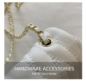 Detail shot of golden metal hardware on white quilted leather bag with chain strap
