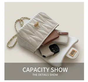 Detail showing internal capacity of the white quilted crossbody bag with personal items