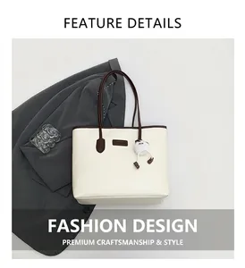 Close-up of cream tote bag with dark brown handles and white plush charm detail