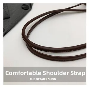 Detailed view of durable brown faux leather shoulder straps with premium stitching