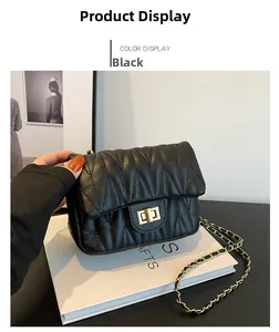 Detail of black quilted faux leather shoulder bag with gold chain strap and metal lock