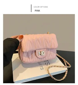 Pink quilted chain crossbody bag with golden twist lock and hand-held proportion view