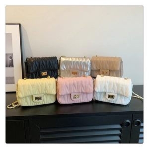 Group shot of colorful wavy quilted shoulder bags with gold chain straps and twist locks