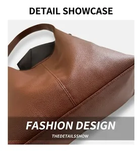 Close-up of litchi grain brown leather tote bag showing high-quality stitching and texture