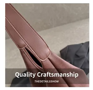 Detailed macro view of the brown lychee-textured leather strap and neat stitching craft