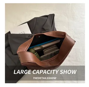 Interior view of large brown pebble leather tote bag with magnetic closure and daily essentials