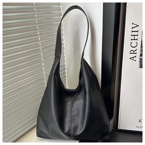Detailed view of the black lychee pattern leather tote bag with elegant vertical stitching