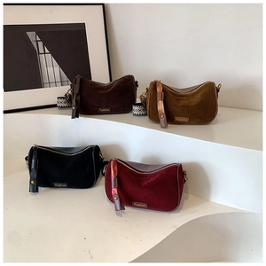 Close-up of vintage velvet pillow bags in four colors with retro patterned wide straps