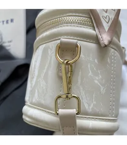 Close-up of marble pattern faux leather with premium gold metal hardware and silk ribbon