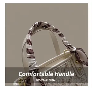 Detail of elegant top handle with silk houndstooth scarf and vintage horse pattern