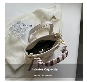Detailed view of the handbag interior capacity with a printed scarf handle and golden zipper