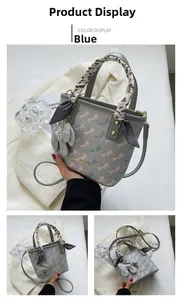 Detail of grey bucket bag with printed horse pattern and silk scarf wrapped handle