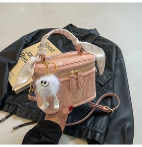 Pink box crossbody bag with marble texture, silk scarf handle and plush monster charm